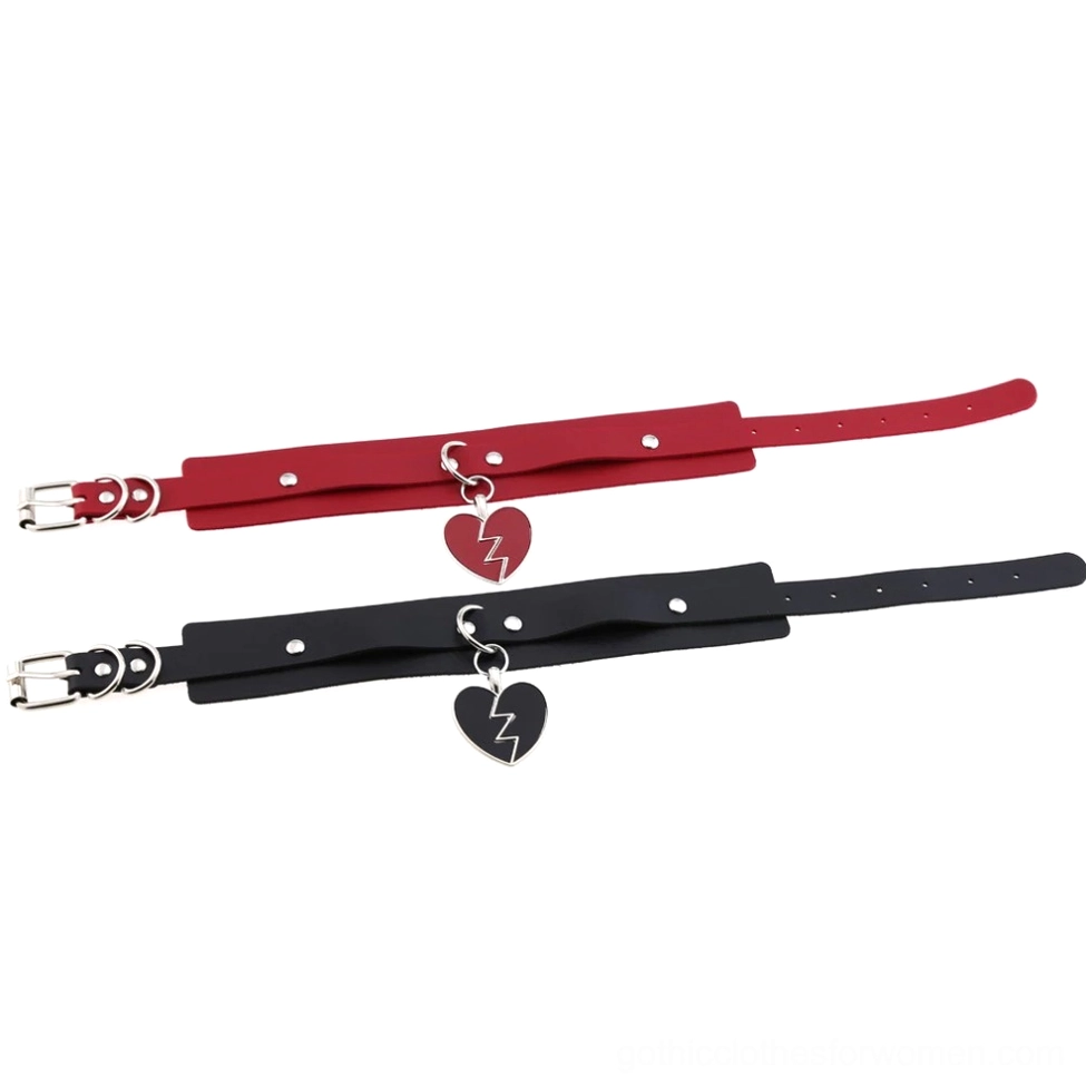 Overhead flat lay view of thin adjustable leather chokers with small heart pendants and metal buckles
