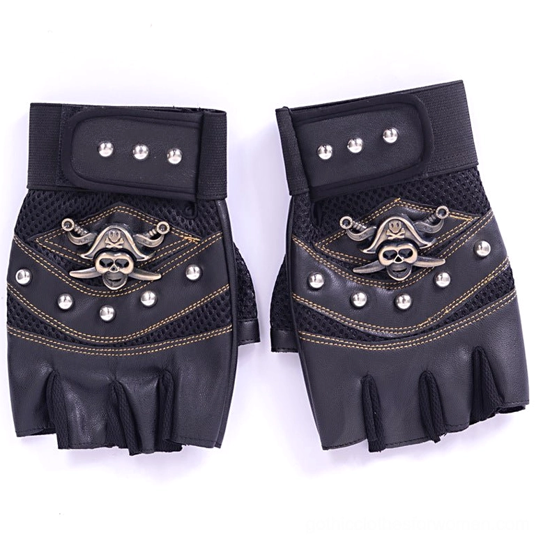 All-black half-finger gloves with pirate skull logo and metal studs on pure white flat lay surface
