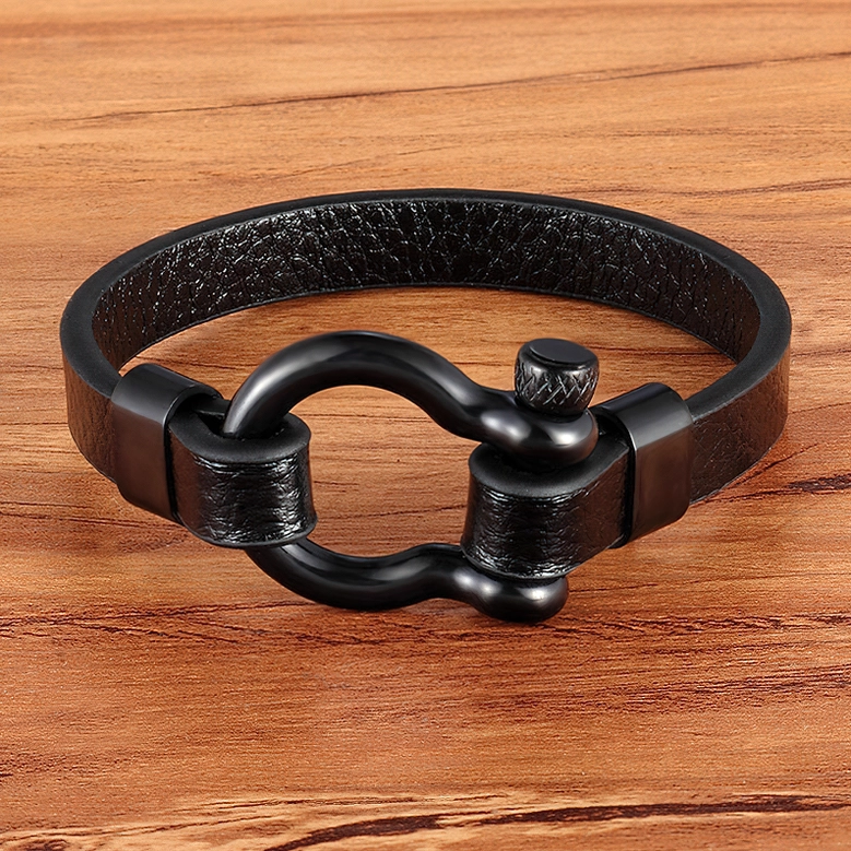 All-black matte leather toggle clasp bracelet with dark hardware, front flat view on wooden tabletop display