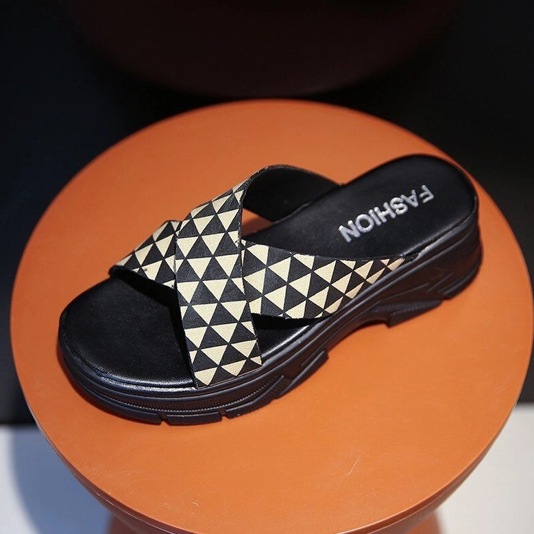 Single khaki and black crisscross platform slide with fashion printed insole, top-front view showing geometric triangle pattern