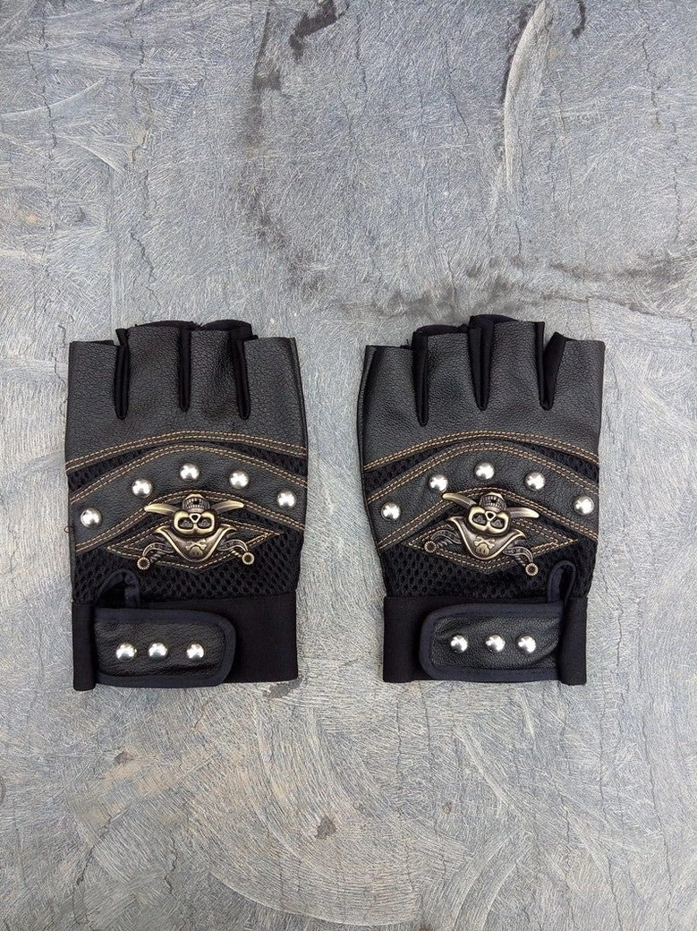 Alternative fashion skull rivet fingerless gloves close-up showcasing craftsmanship and industrial design