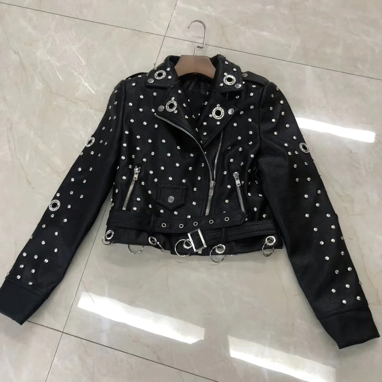 Studded gothic leather jacket hanging display showing dual side zippers and adjustable waist strap