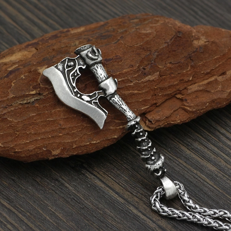 Antique silver Viking axe pendant on wheat-link chain, side view showing mythological craftsmanship