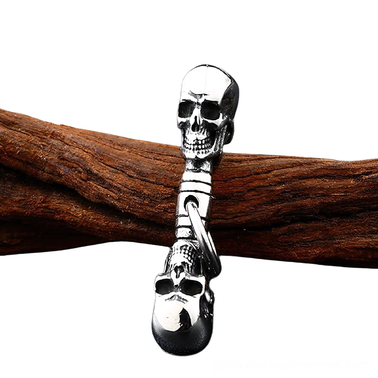 Antique silver tone double skull pendant on wooden background, gothic statement jewelry