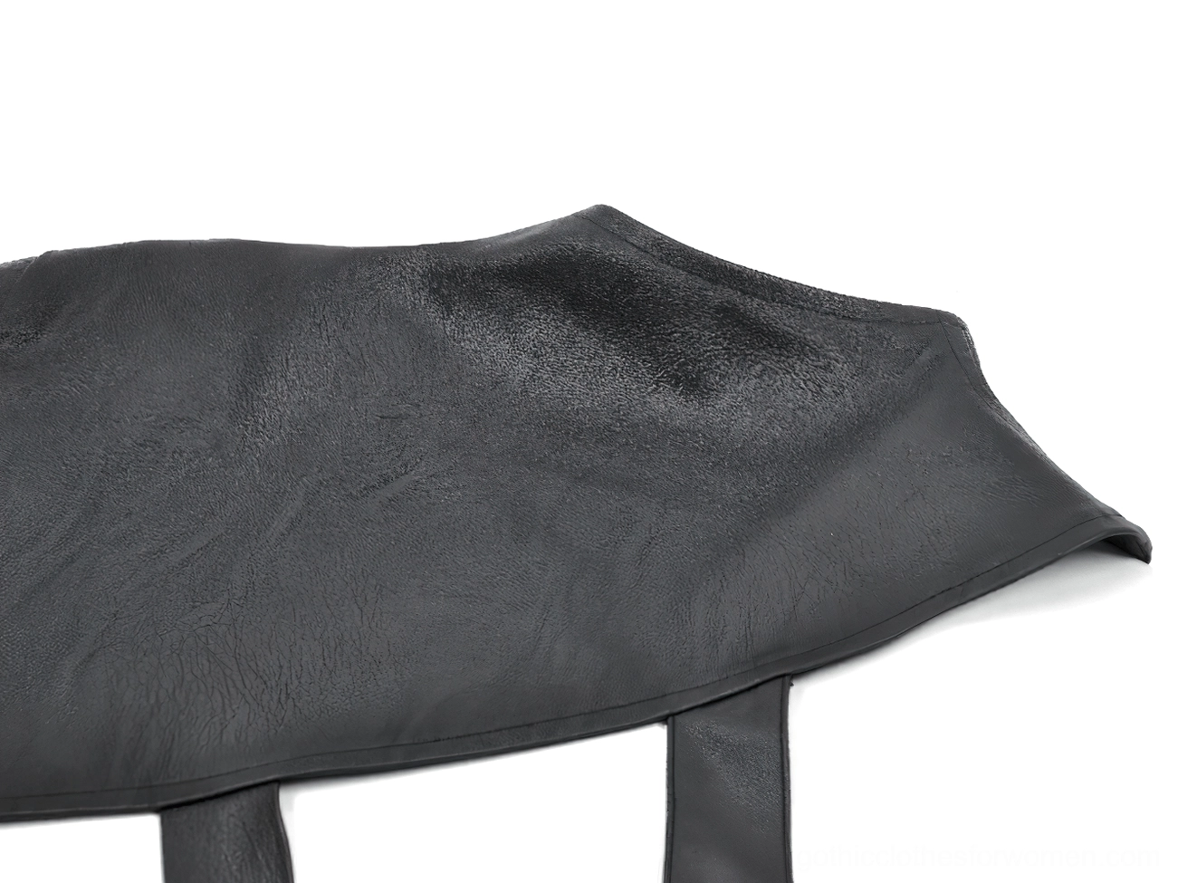 Detailed view of asymmetric punk leather shoulder cape construction and metal embellishments