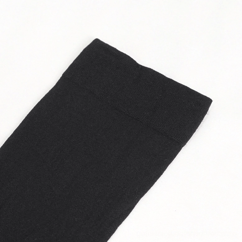Asymmetrical gothic knee-high socks with metal heart garter detailed product shot for alternative fashion collection