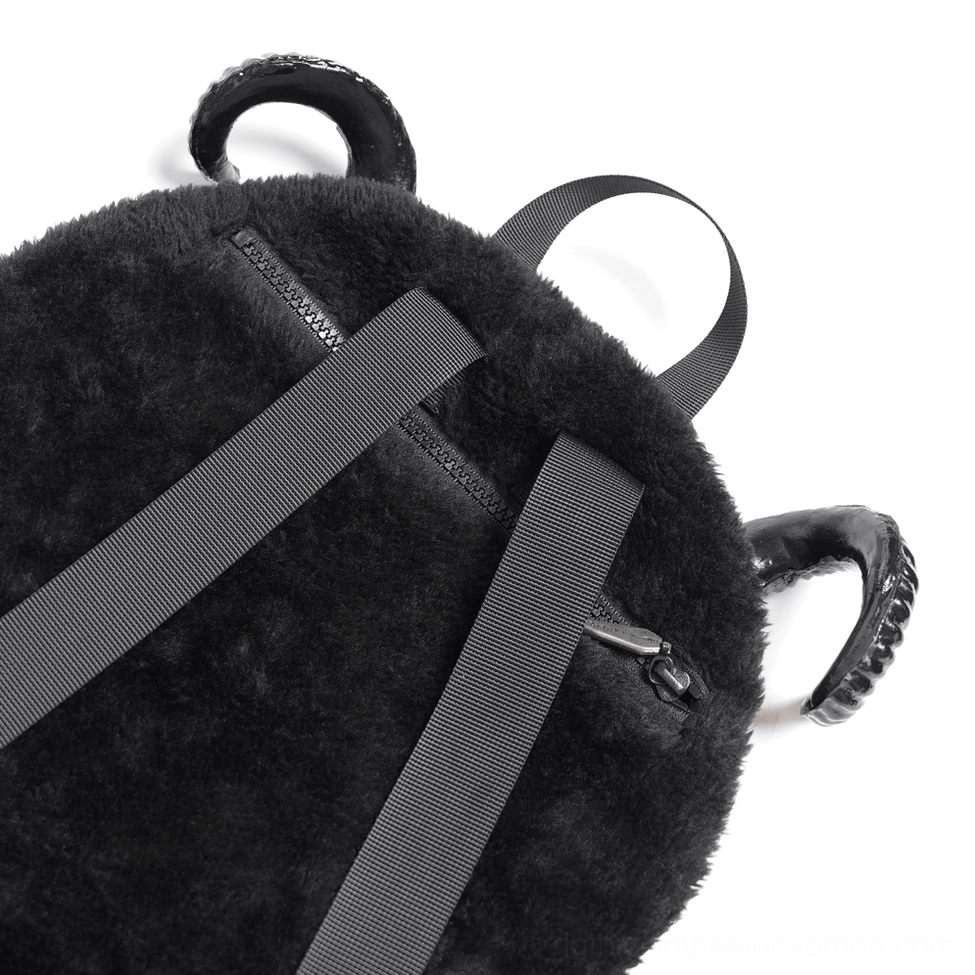 Close-up detail shot of gothic backpack strap and rear showing soft fleece fabric texture and side zipper pocket