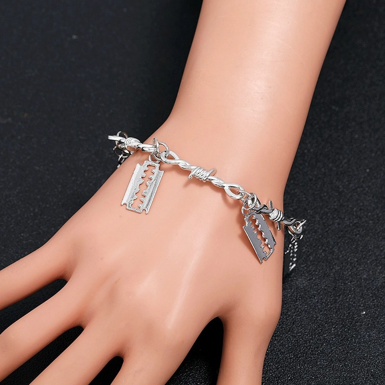 Silver barbed wire blade gothic bracelet displayed on mannequin hand, front side view showing twisted barbed chain and alloy finish