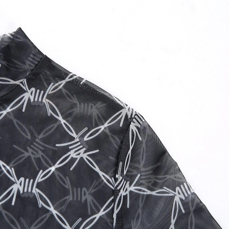 Close-up detail of barbed wire mesh crop top sleeve showing intricate mesh texture and print