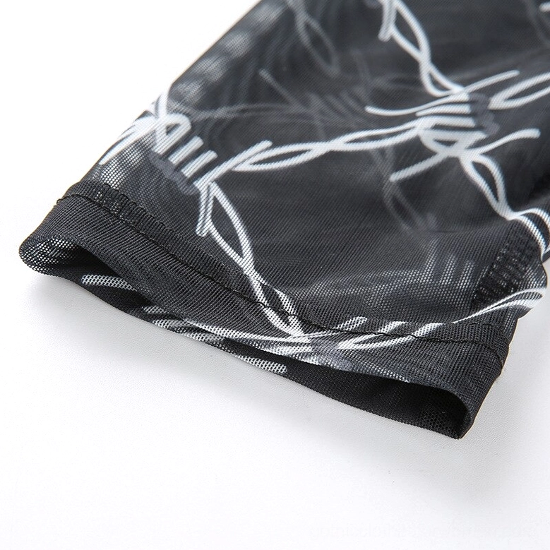 Black barbed wire mesh long-sleeve crop top flat lay product photography