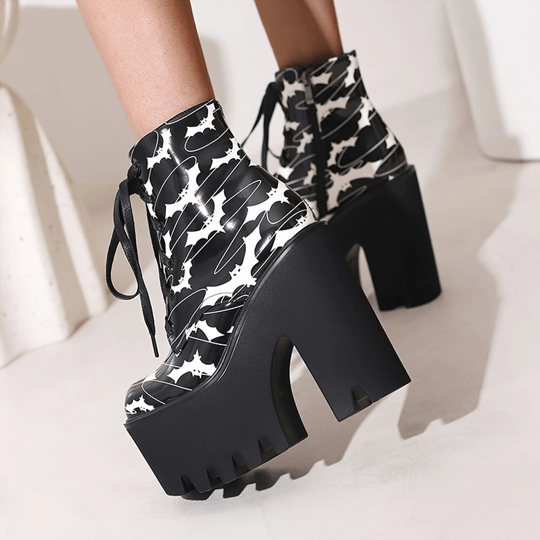 Black gothic bat print platform ankle boots, angled three-quarter view showcasing the microfiber upper texture and chunky square heel profile