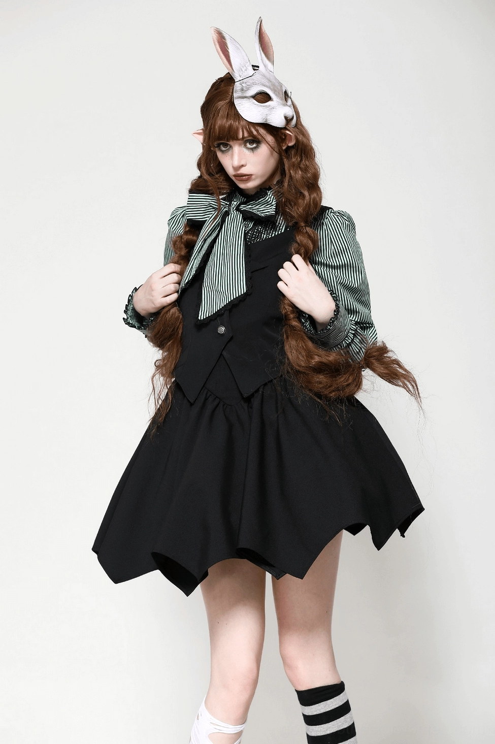 Bat wing corset top model showcase featuring costume-forward styling with striped blouse and gothic accessories