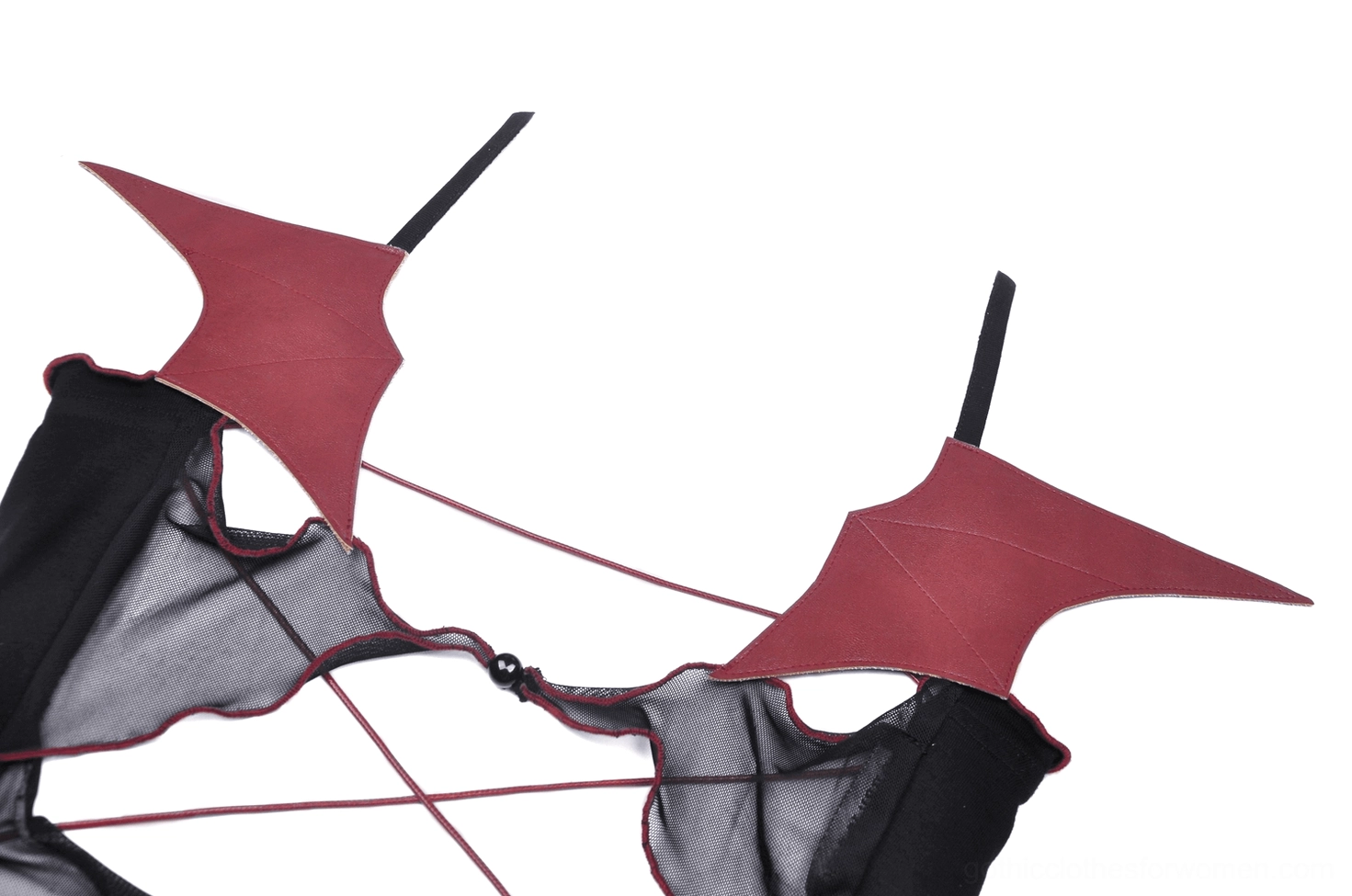 Red faux leather batwing accessory close-up with black straps showing gothic aesthetic detail