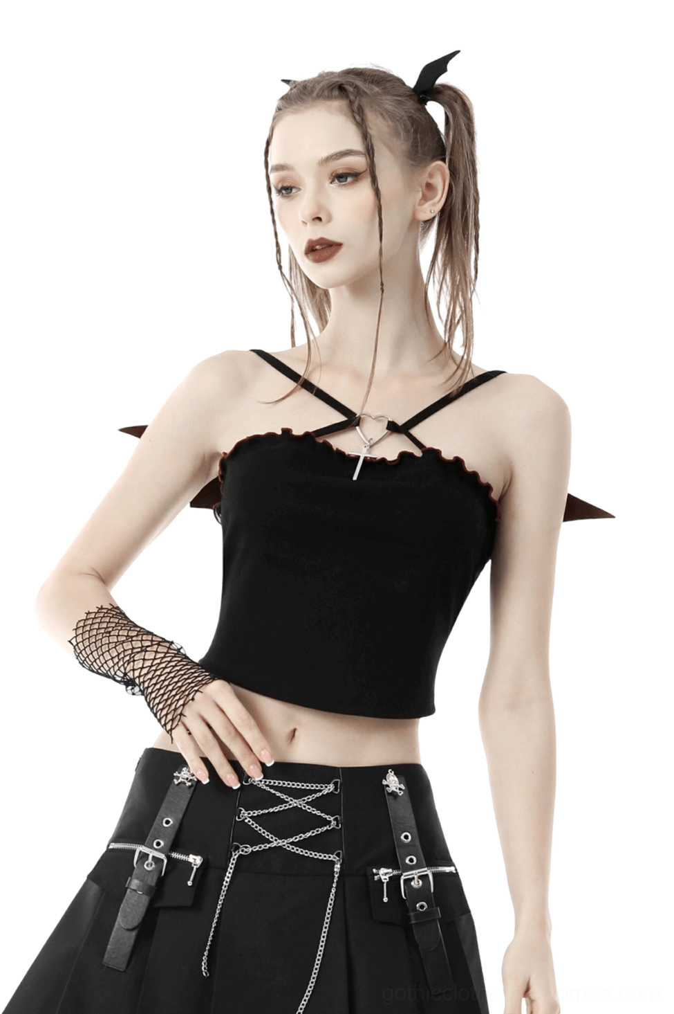 Black batwing gothic crop top front view on model with twin hair bows, featuring ruffled trim and heart cross pendant