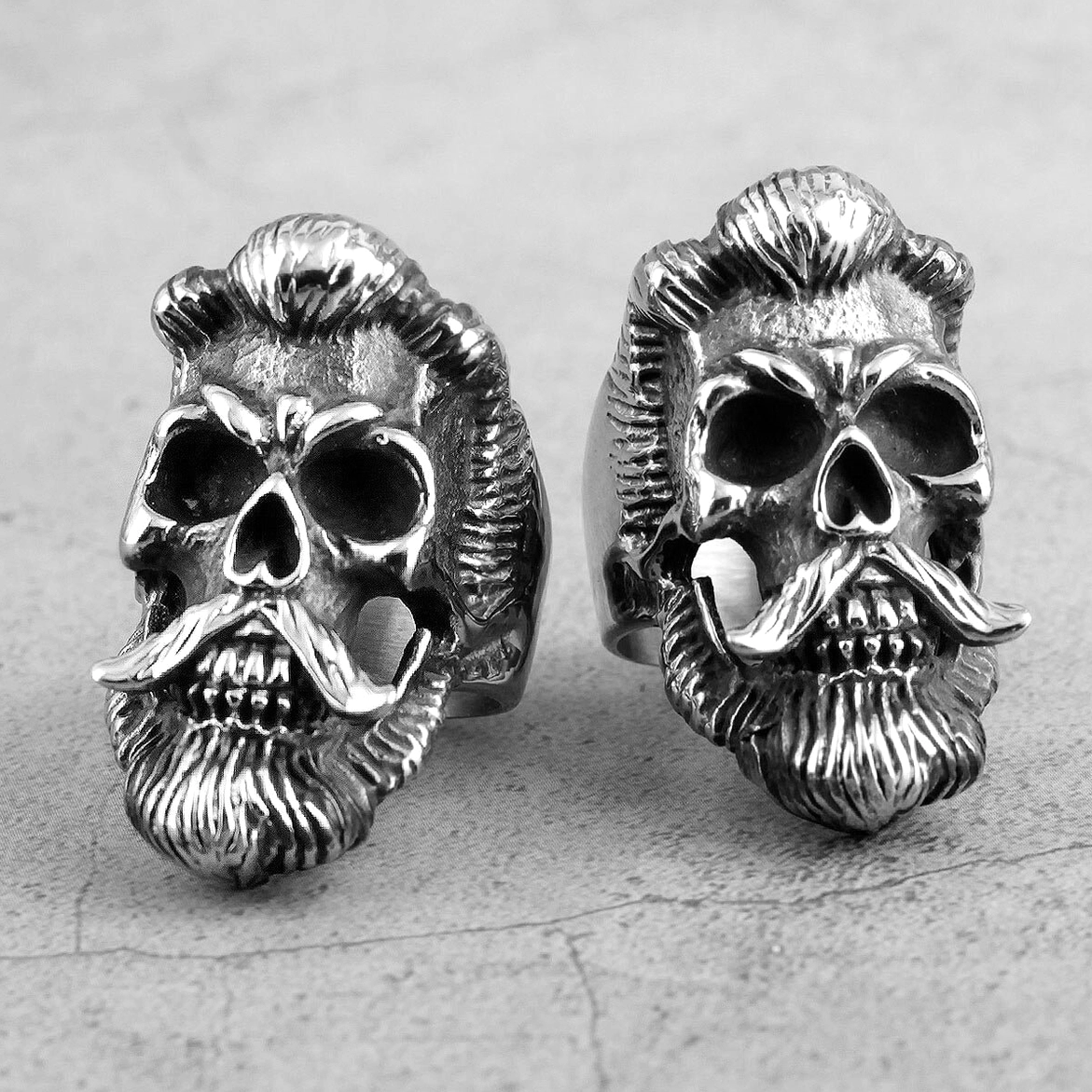 Pair of bearded gentleman gothic skull rings with realistic carved beard and mustache details in silver stainless steel