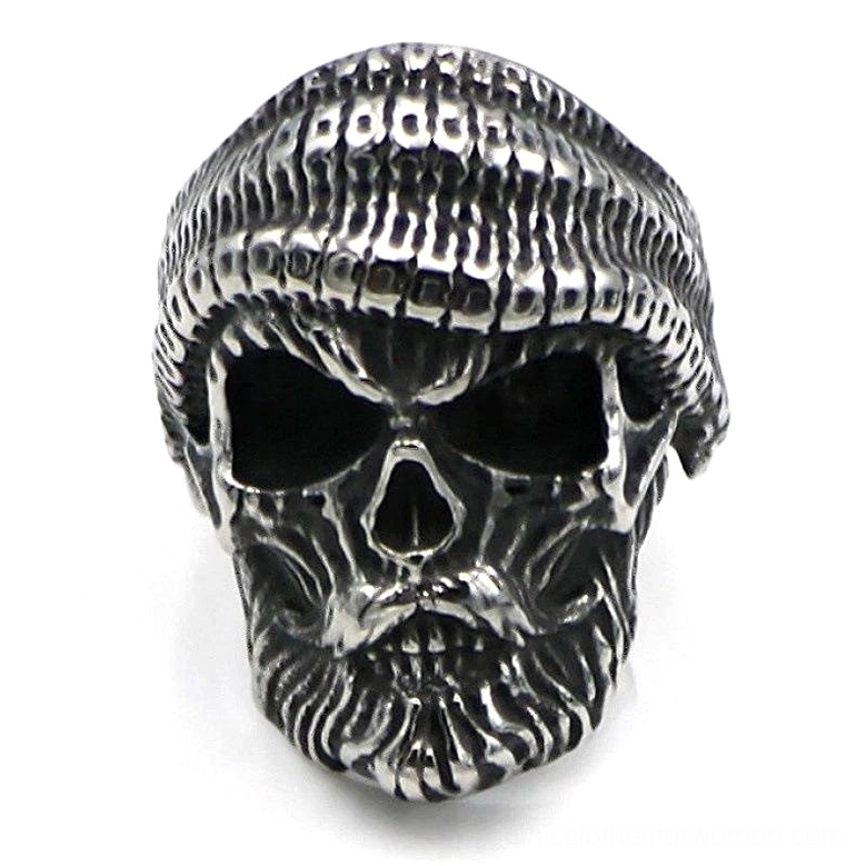 Frontal close-up of bearded skull ring displaying aggressive facial features and hand-knitted hat texture in antique silver