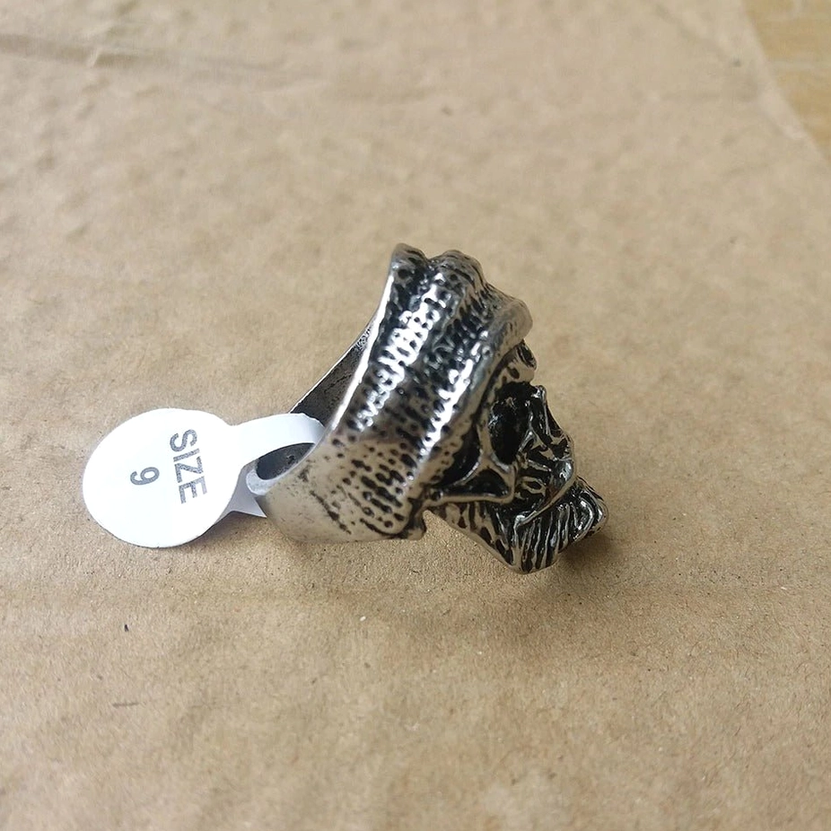 Bearded skull gothic ring side profile on cardboard with size 9 hang tag showing vintage silver metal finish
