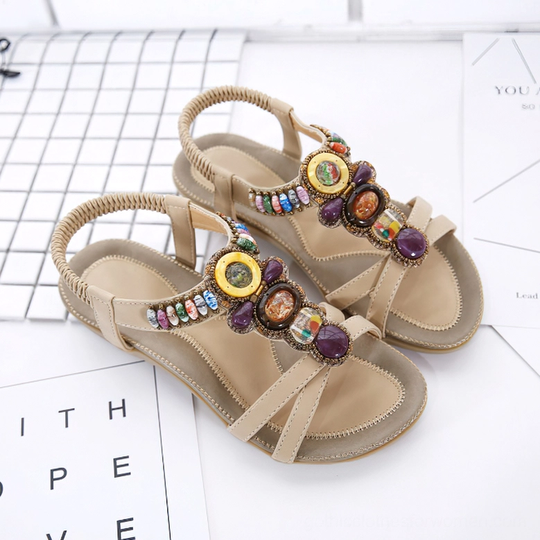 Beige beaded gothic sandal quarter view showing ankle strap elasticity and gemstone decorations