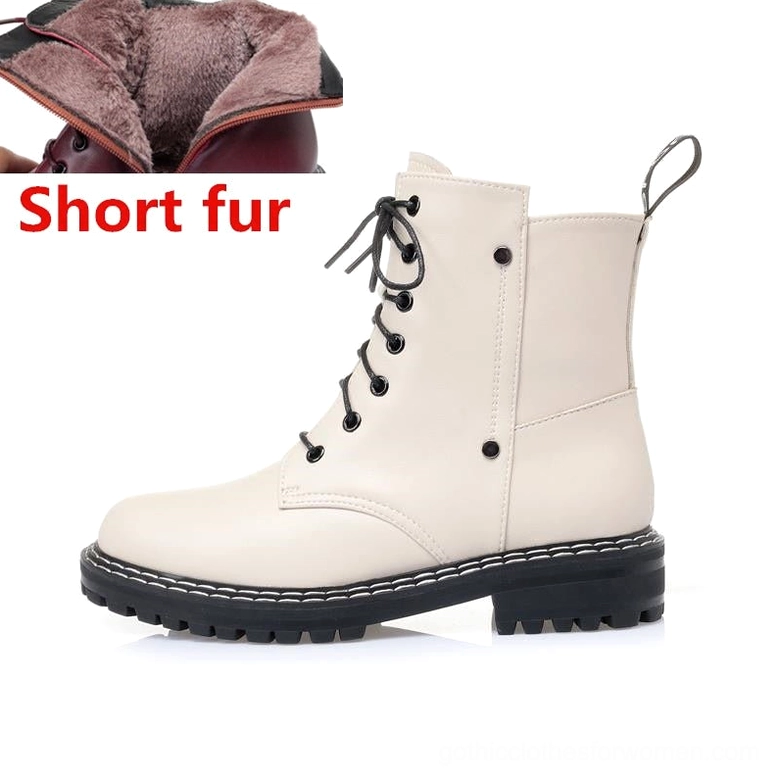Beige leather ankle boot side view with wool fuzzy lining and stitched rubber outsole