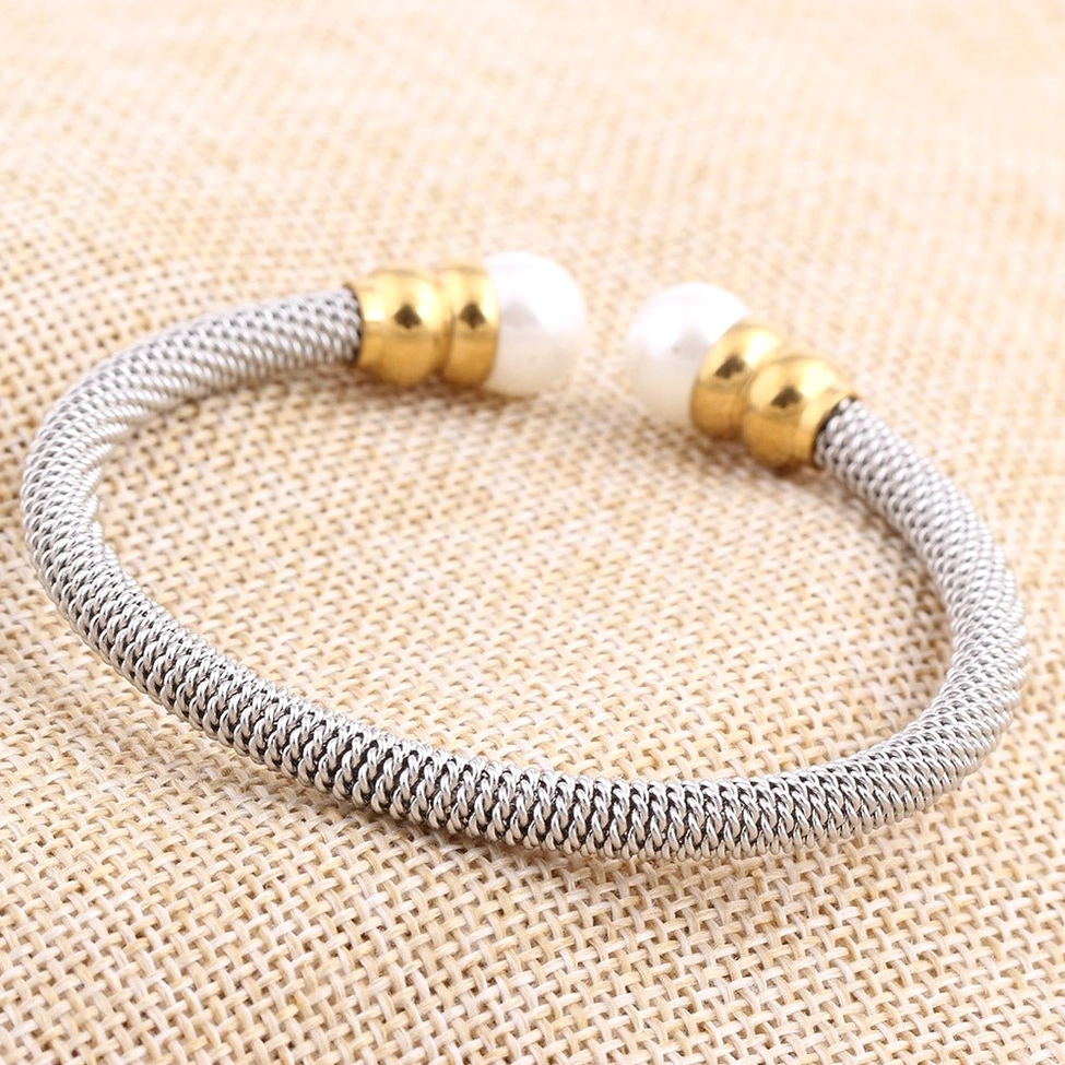 Perfectly round simulated pearls in bezel settings on dual-tone stainless steel gothic bracelet