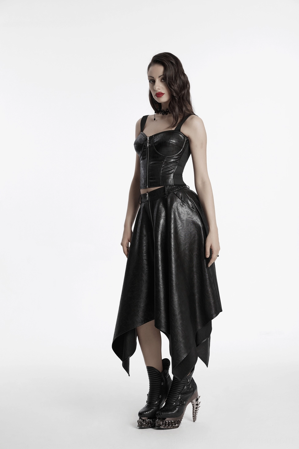 Black faux leather asymmetrical skirt showing lustrous finish and wrinkled texture throughout