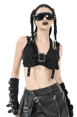 Black baroque harness crop top front view on model with braided hair, featuring ornate silver buckle and studded arm details