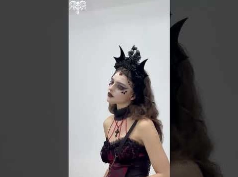 Gothic bat crown headpiece side profile view showing architectural wing design and floral accents
