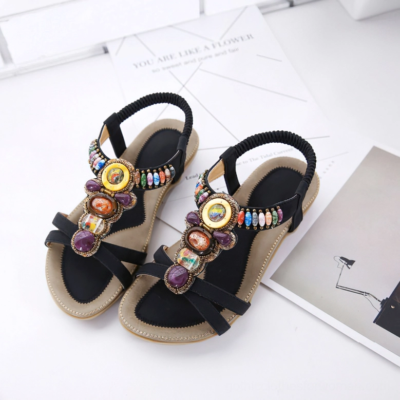 Black beaded gothic sandal showing elastic ankle strap flexibility and colorful gemstone placement