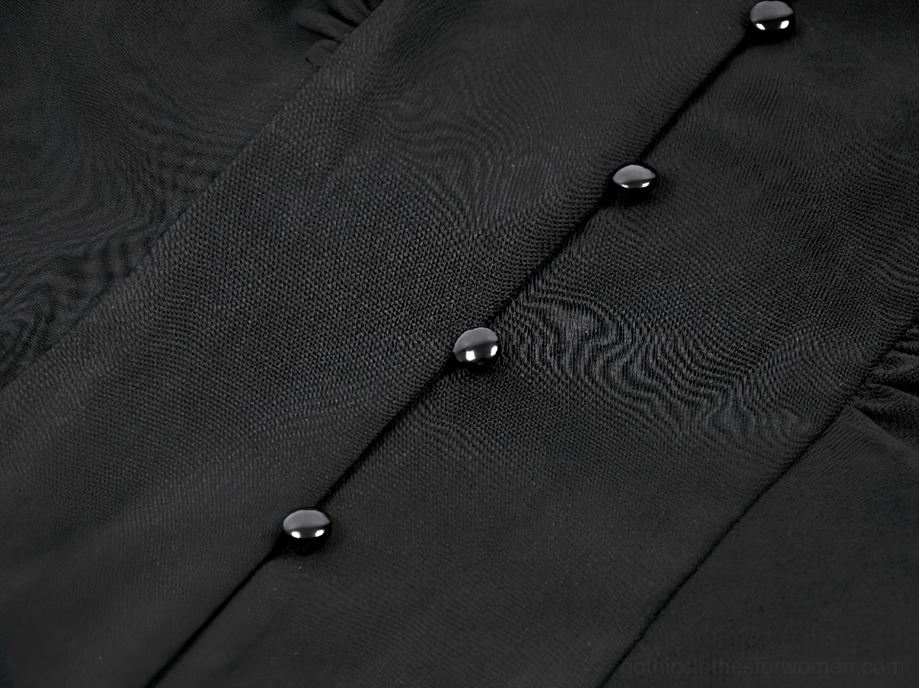 Black button closure detail on gothic ruffled blouse front fastening