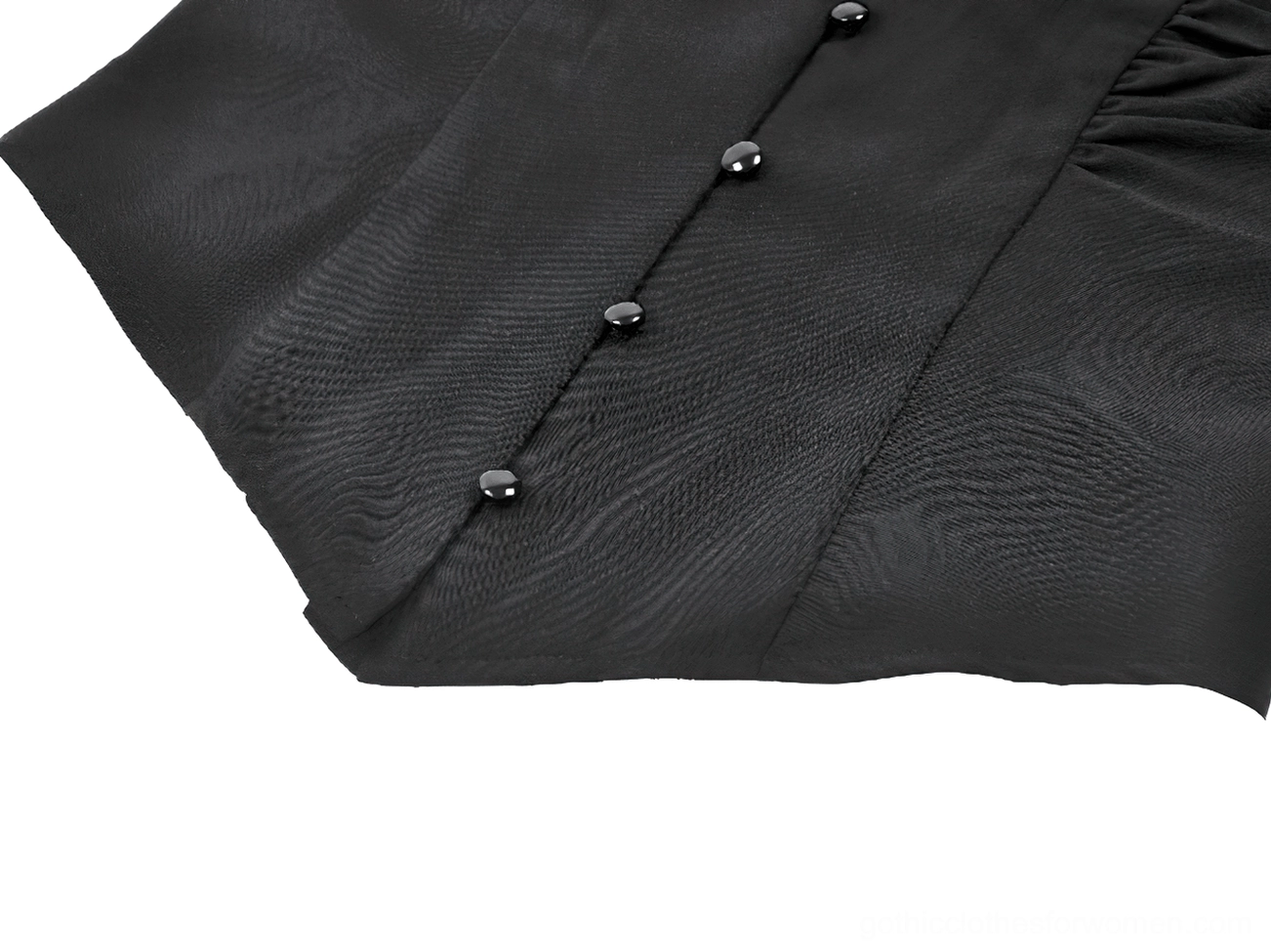 Close-up view of decorative black buttons on gothic blouse tailored fabric
