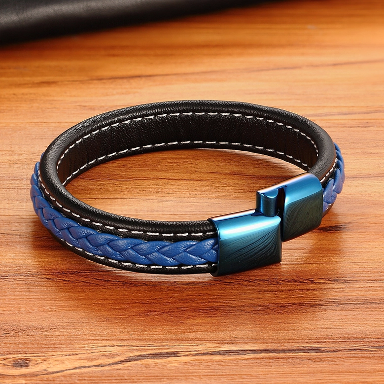 Black and blue striped leather gothic bracelet on wooden table, color-blocked design