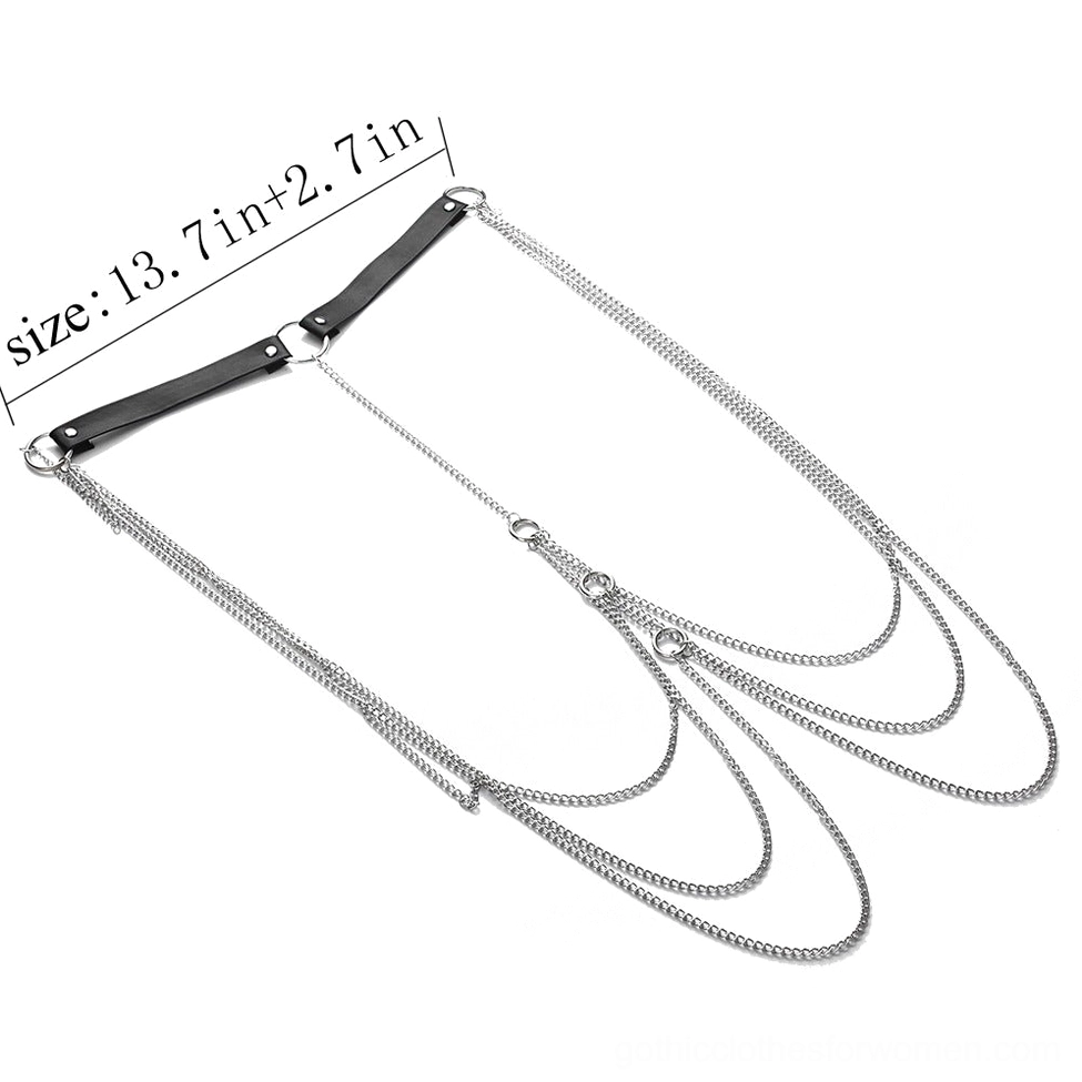 Flat lay product photography of black faux leather body harness with silver metal chains and adjustment rings