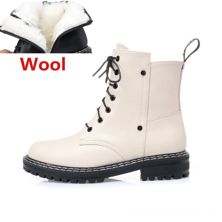 Black leather combat boot back view showing heel construction and wool lining depth