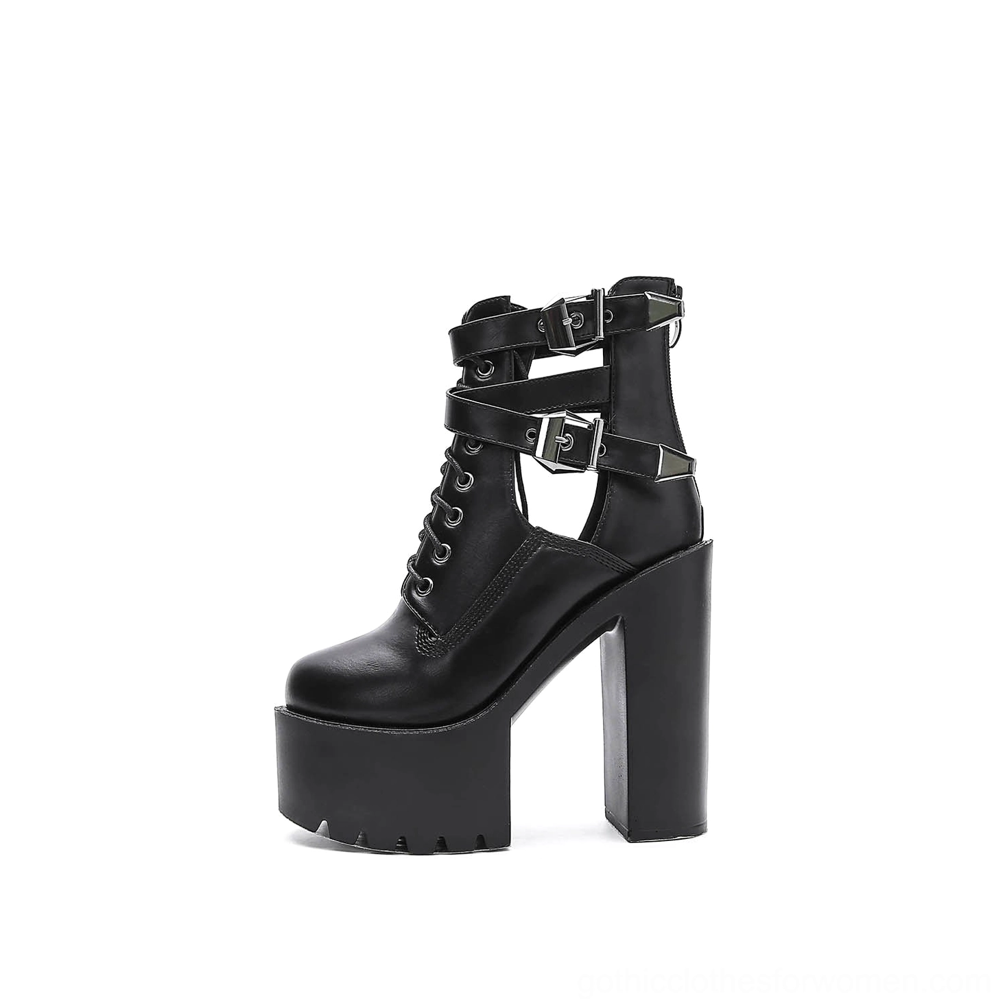 Black platform ankle boots with architectural cutout panels on sides, decorative buckle straps, and round toe shape, front three-quarter angle