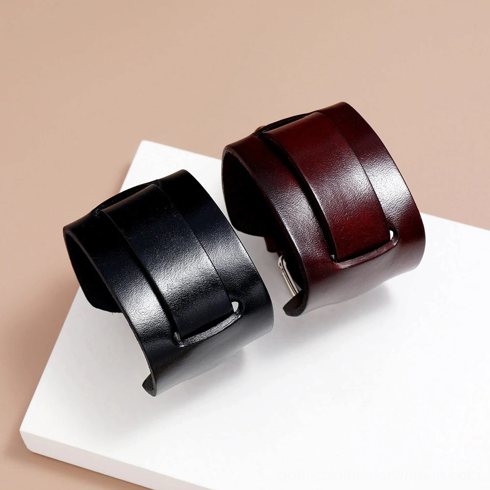 Pair of wide leather cuff bracelets in black and brown displayed together, showing color comparison and cuff style