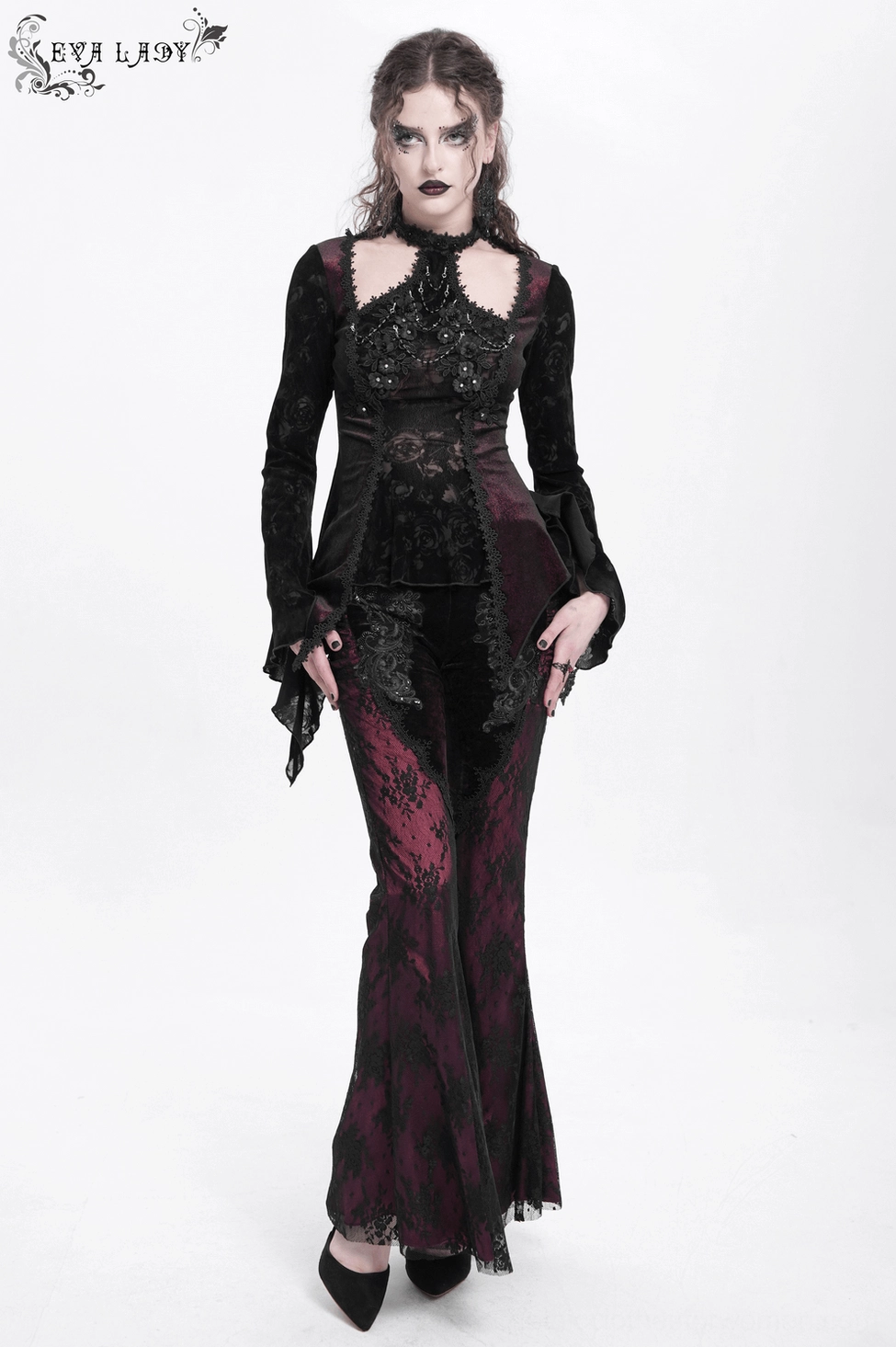 Black-burgundy gothic velvet flare pants with sheer lace leg panels and ruched details showing witchy aesthetic styling