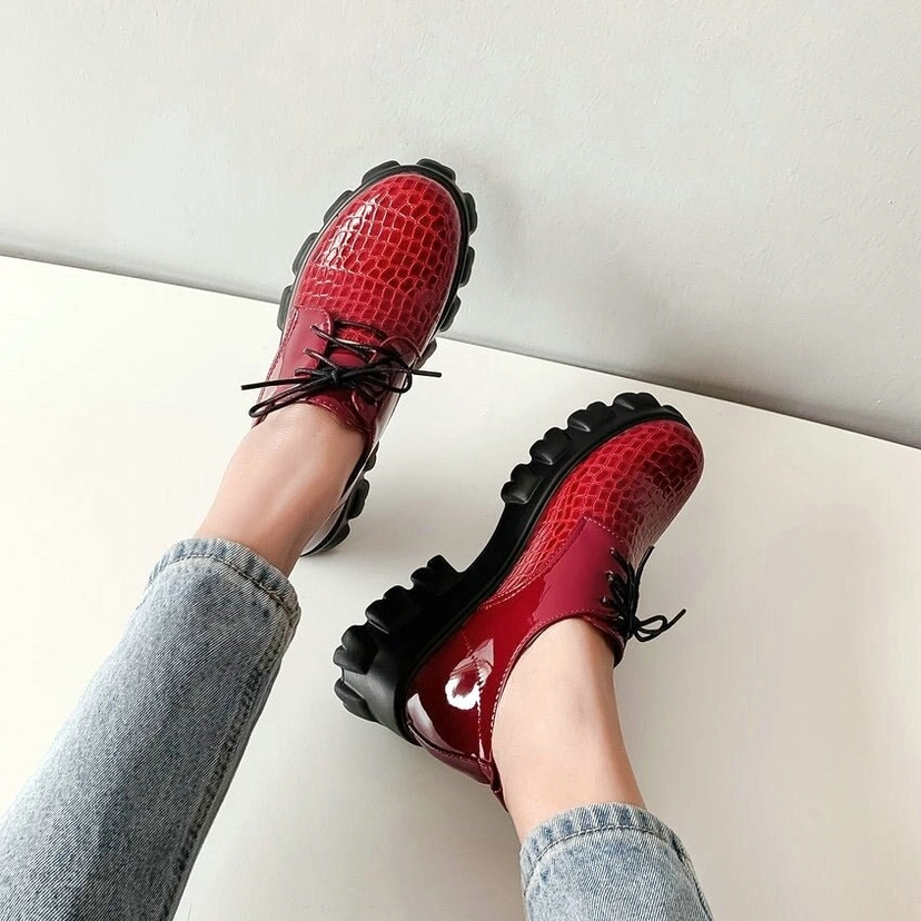 Black and burgundy snake-pattern platform pumps comparison showing color variations and texture consistency