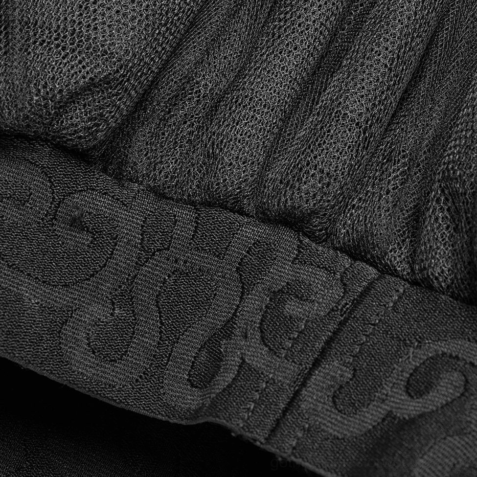 Close-up of embroidered jacquard waistband with stitched branded detail on gothic skirt