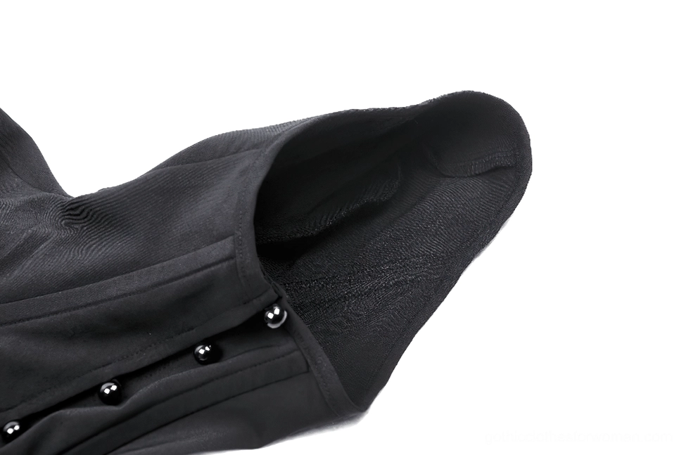 Side close-up view of cape button fasteners and stretchy matte black textile construction detail