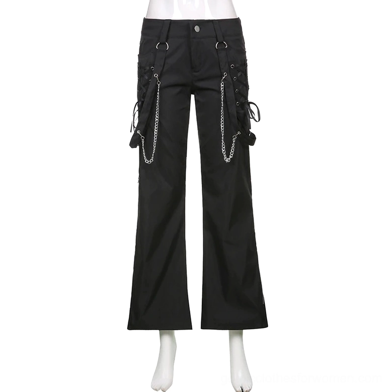 Black punk cargo pants on mannequin front display, showcasing chain and lace-up pocket decorations in white studio setting
