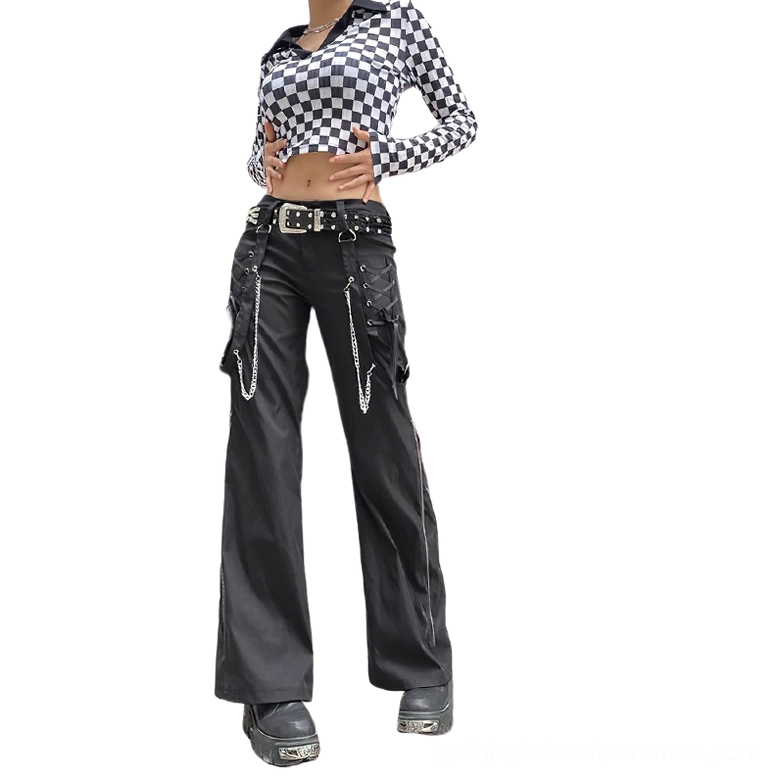 Black gothic cargo pants with chain embellishments, worn by female model in white studio, front full-body view showcasing wide-leg silhouette and metal hardware details