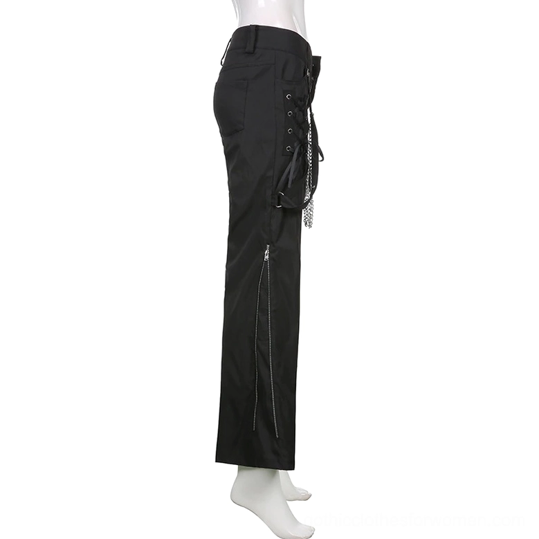 Black punk cargo pants on mannequin side view, displaying side zipper design and industrial pocket details
