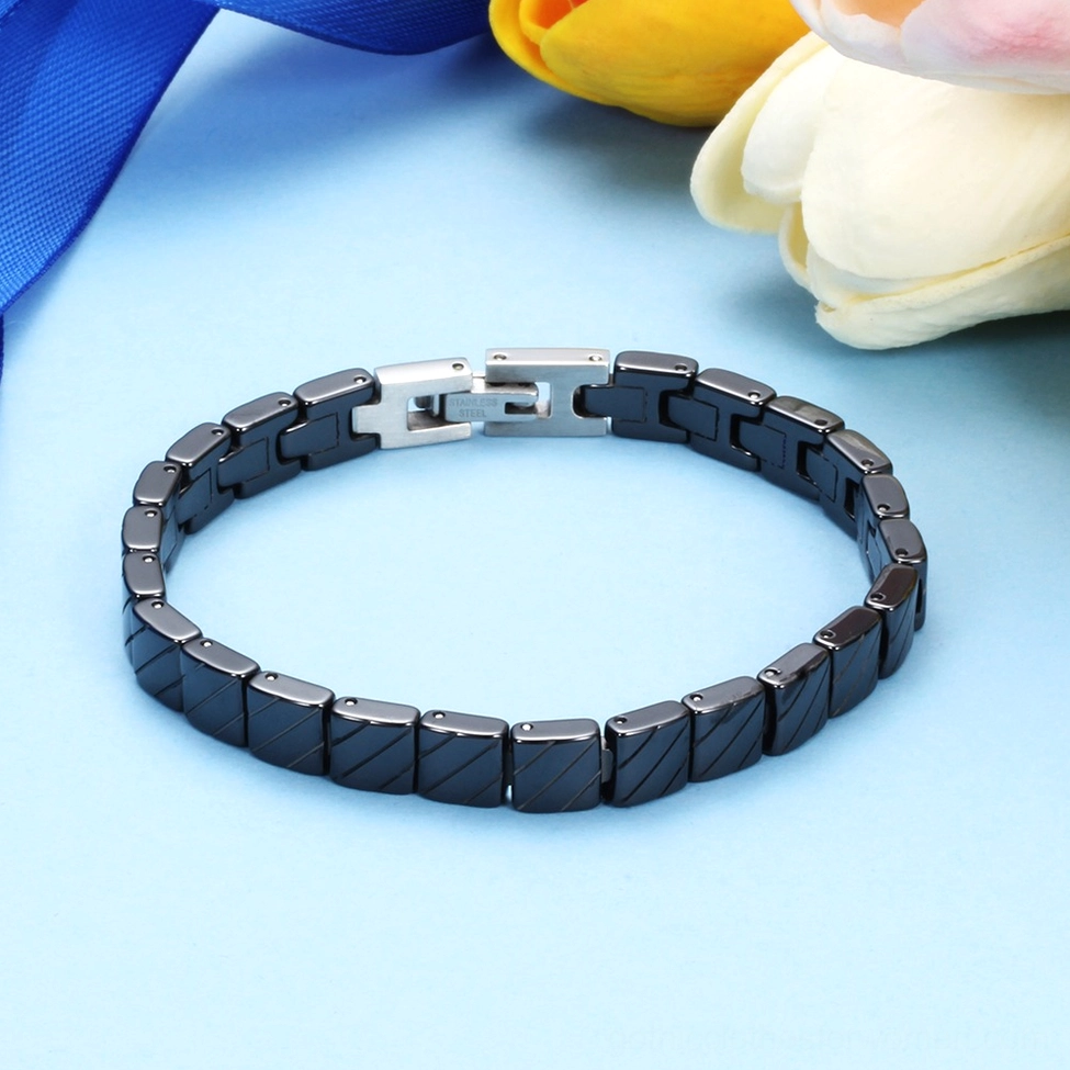 Black ceramic bracelet on reflective glossy background highlighting texture and finish