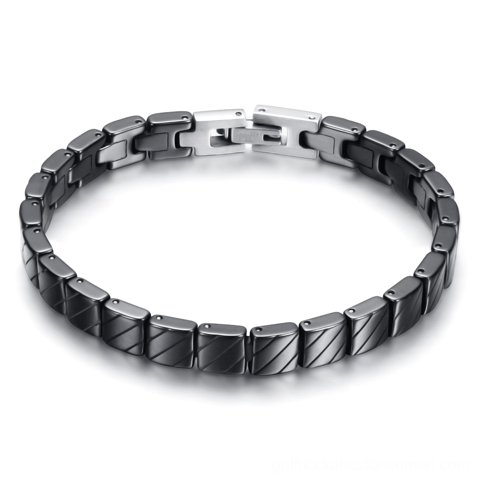 Black ceramic link bracelet with textured finish and silver toggle clasp, overhead flat lay view