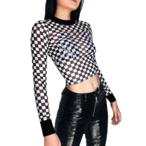 Black checkerboard mesh long-sleeve crop top with mock turtleneck – front view on model, sheer mesh fabric with black-white checkered pattern, fitted silhouette, cropped length