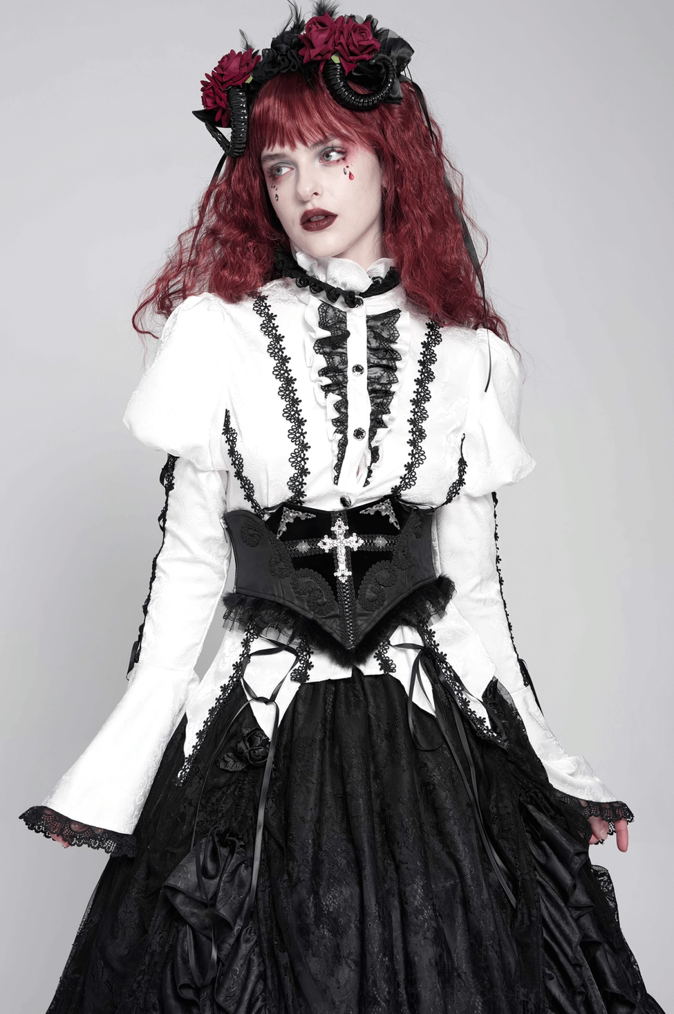 Black corset belt with cross embroidery side profile detail shot showing tulle trim, embroidered pattern, and matte black fabric premium quality