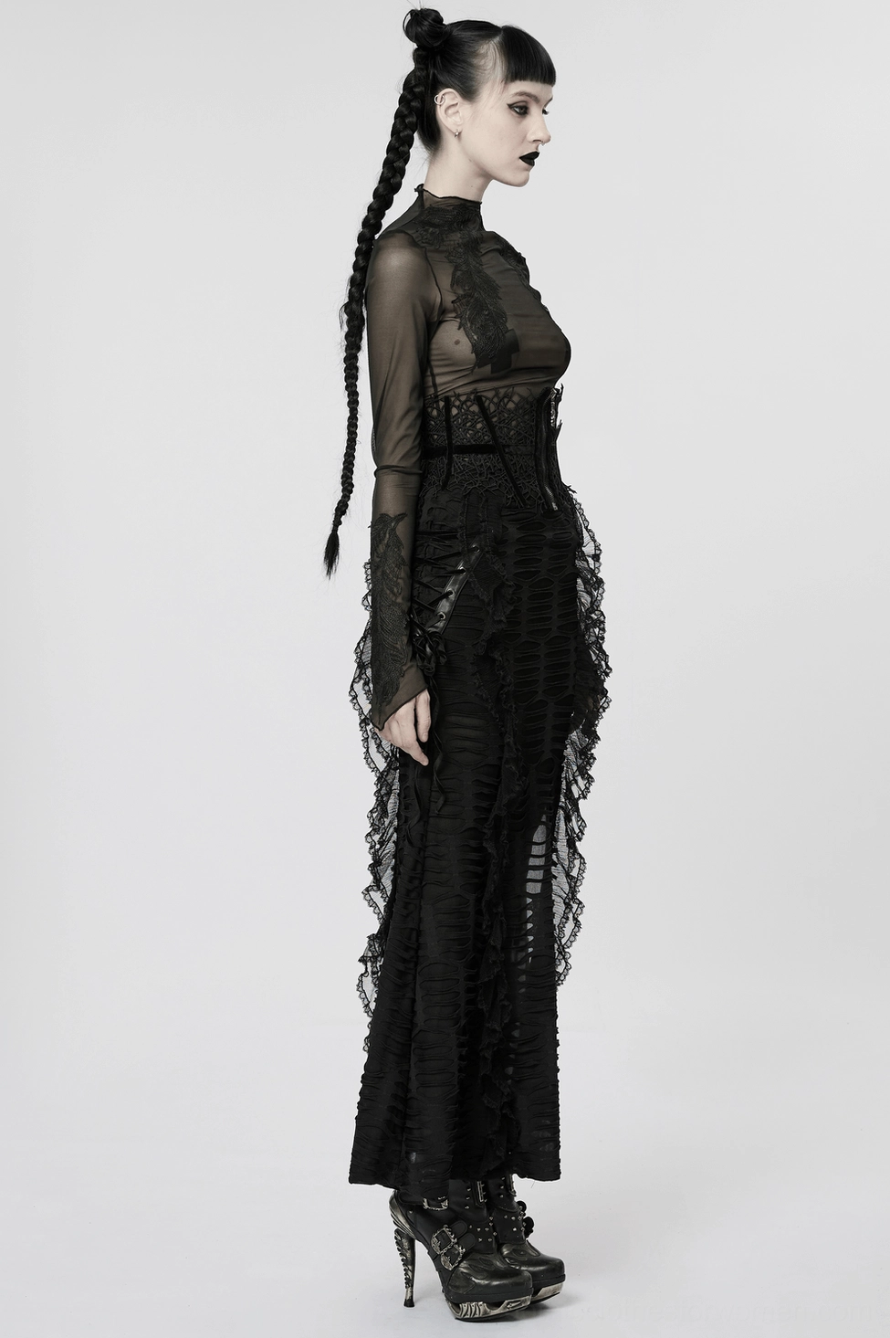 Black corset belt detail shot showing velvet webbing cross straps and metal zipper closure on model