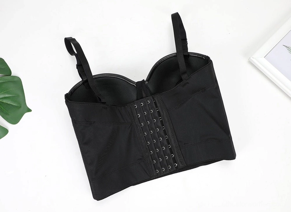 Black leather gothic corset bra back flat lay with decorative elements, showing multi-row hook-and-eye closure system