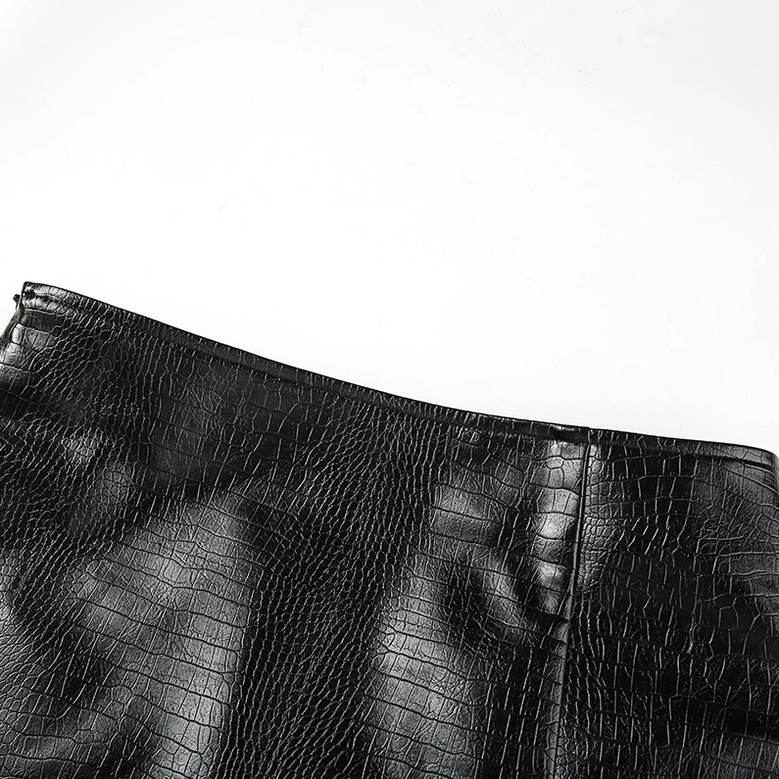 Close-up of black crocodile embossed PU leather texture and seam construction details on gothic mini skirt
