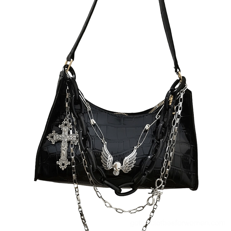 Black crocodile leather gothic handbag featuring ornate cross and skull decoration, shoulder bag style